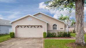 A single-story house with a garage, a brick section on the front, and a well-maintained lawn.