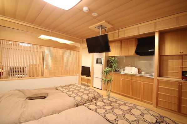Relax in this compact room with a bed against a wall, flanked by windows and a flat-screen TV.