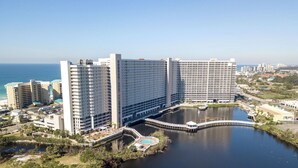 A large hotel with multiple high-rise buildings, a central courtyard, and a body of water. - TOO BEAUTIFUL GULF and SUNSET VIEWS! (Panama City Beach)