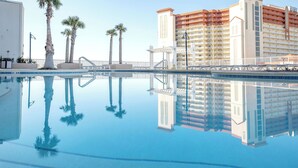 A hotel with a swimming pool, palm trees, and a reflection of the building. - TOO BEAUTIFUL GULF and SUNSET VIEWS! (Panama City Beach)