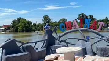 A sign reading 'CHAINAT' with a boat-shaped structure and seating area.