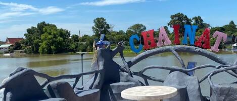 A sign reading 'CHAINAT' with a boat-shaped structure and seating area.