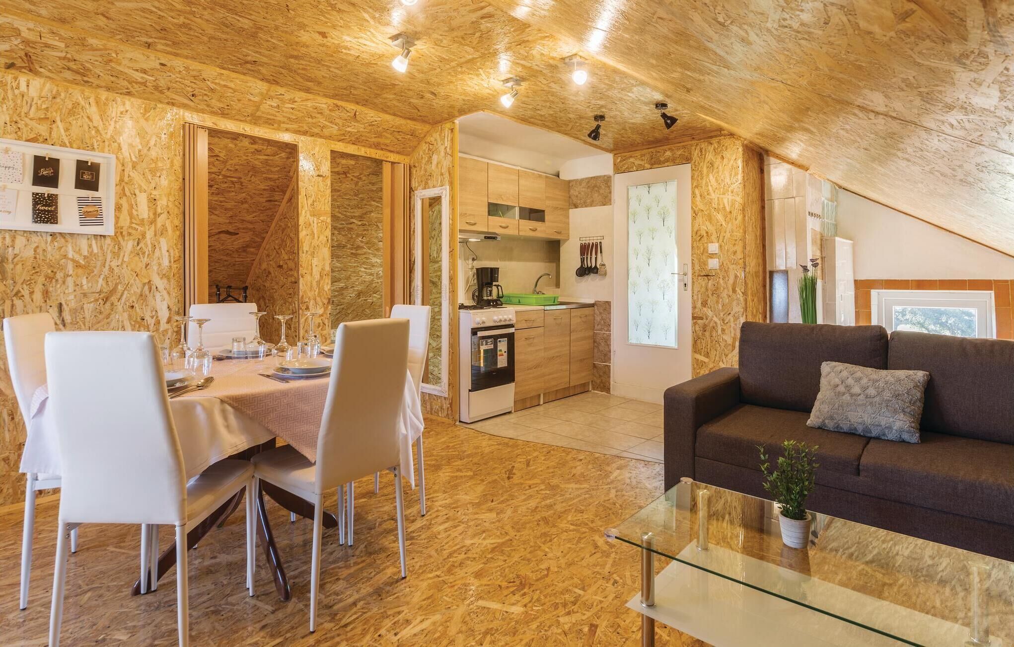 A cozy interior with a dining area, kitchen, and living space.