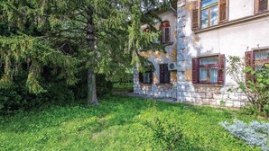 A stone building with traditional wooden shutters, surrounded by lush greenery and trees. - 1 bedroom awesome apartment in Bakar (Bakar)
