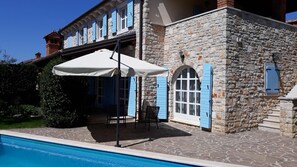 A stone building with a pool, outdoor seating, and a pergola with a white umbrella. - Lovely Stone House with Own Pool in Quiet Village (Tar)