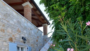 A stone building with a wooden staircase and a window with shutters. - Lovely Stone House with Own Pool in Quiet Village (Tar)