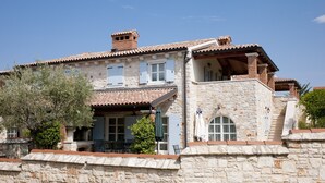 A stone building with a tiled roof, a balcony, and a small garden area. - Lovely Stone House with Own Pool in Quiet Village (Tar)