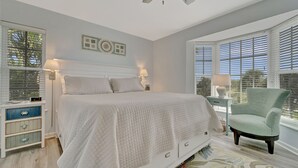 A bedroom with a bed, bedside tables, a chair, and a window with blinds. - Very Nice and Comfortable with a Great View of the Gulf on the Resort, A3724A (Cape Haze)