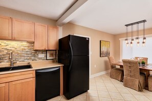 Enjoy meals in this kitchen with a dining area, featuring a window with a view.