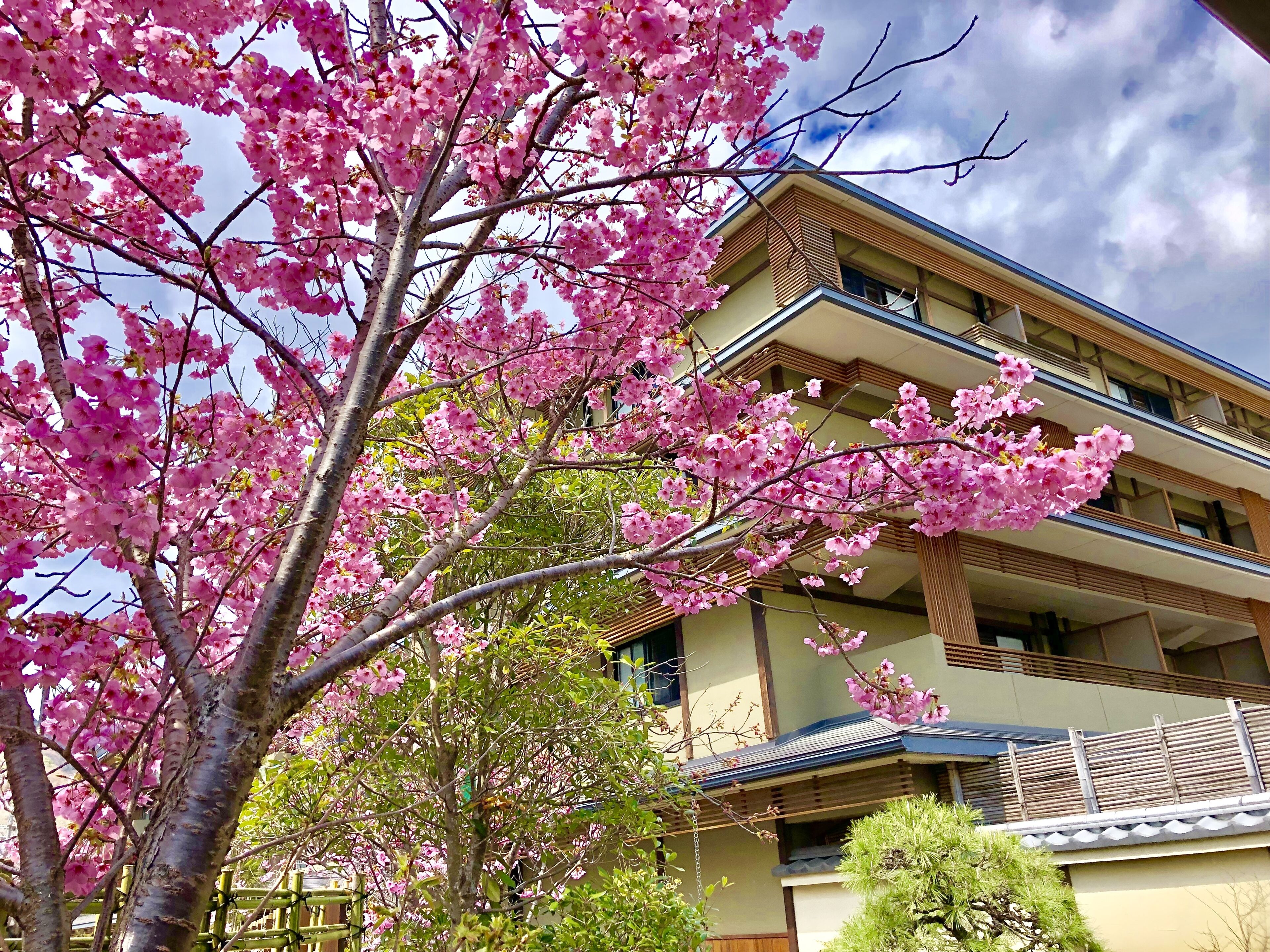 A multi-story building with a traditional architectural style, featuring a balcony on the upper floor.