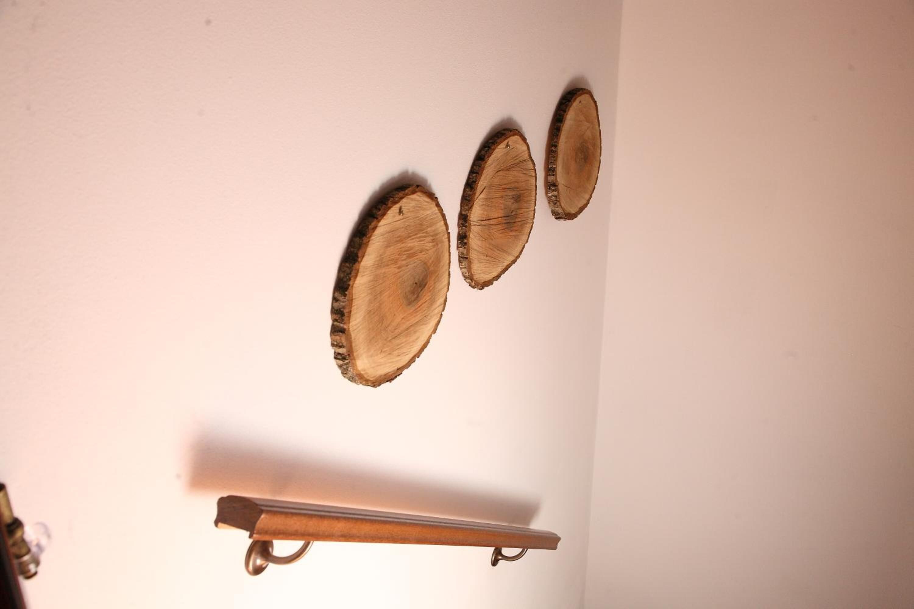 Trois éléments de décoration murale en bois et une étagère en métal.