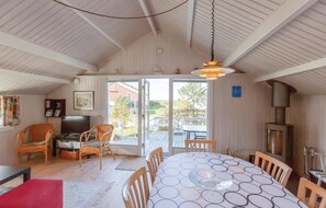 A cozy interior with a dining table, chairs, a television, and a fireplace. - Beautiful home in Brenderup Fyn (Brenderup Fyn)