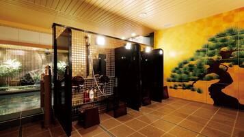 A spa area with a koi pond, wooden ceiling, and a mural of a pine tree.
