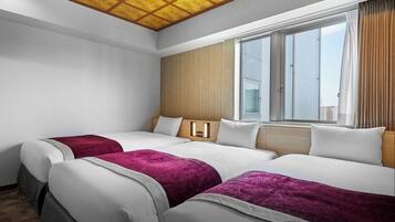 A hotel room with two beds, a large window, and a ceiling with a grid pattern.