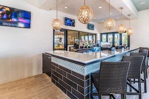 Relax with a drink at the hotel's stylish bar, featuring a long counter and comfortable seating area.