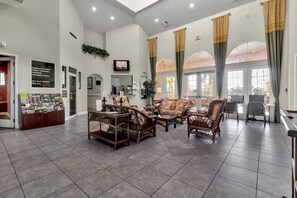 Relax in our welcoming lobby, featuring a reception desk, comfortable seating, and a TV.