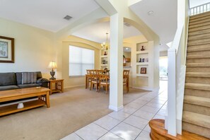 Relax in this open-plan living area with a sofa, coffee table, and dining space.