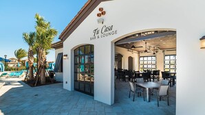 A bar and lounge named 'Tu Casa' with outdoor seating and a pool area in the background. - Brand New Luxurious Pool Home in Westside! 5bd/4ba #5ws690 (Kissimmee)