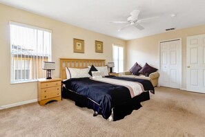 A bedroom with two beds, a ceiling fan, a nightstand, and a window with blinds. - Regal Palms - Spacious 4bed Town House #4rp908 (Davenport)