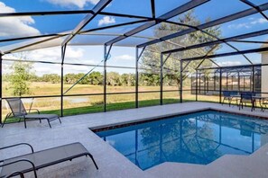 A pool area with a clear view of the surrounding landscape, including trees and open fields. - Marbella South - Lovely 5bd/3.5ba PH #5ms040 (Davenport)