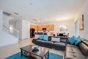 Relax in this stylish living space with a comfortable sofa, coffee table, and dining area.