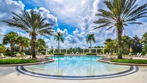 A large outdoor swimming pool surrounded by palm trees and lounge chairs. - Watersong - 6bd/5.5ba Pool Home #6wr120 (Davenport)