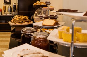 A buffet with various food items including pastries, bread, and desserts. - The Parisian Hotel Lebanon  (Beirut)