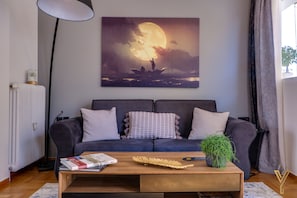 Luxury Apartment, City View | Living area | 50-inch Smart TV with digital channels, TV, books