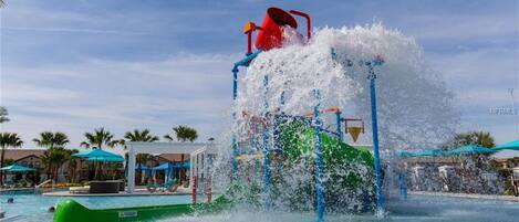A water park with a water slide and a pool area.