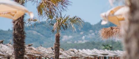 Private beach, white sand, sun loungers, beach umbrellas