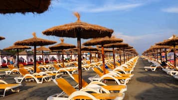 Private beach, white sand, sun loungers, beach umbrellas