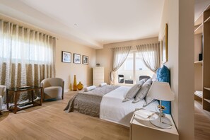 A modern bedroom with a bed, bedside table, lamp, chair, and curtains. - Villa Cipriana (Tar-Vabriga)