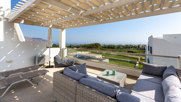 A covered outdoor seating area with a view of the sea, a pool, and a tennis court. - Triton Sea View 7 - two bedroom house close to the sandy beach (Asprouliani)