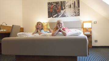 Relax in comfort with a large bed, a shelf, and a wall-mounted lamp.