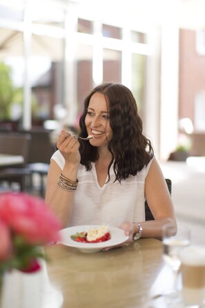 A person sitting at a table with a plate of food.