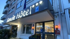 A hotel entrance with a sign reading "Savoie Hotel" and a parking sign. - Savoie Hotel (Saint-Julien-en-Genevois)