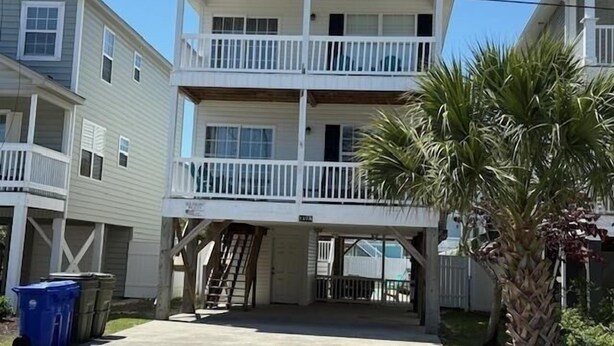 A two-story building with a balcony on the upper floor.