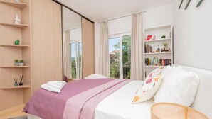 A bedroom with a bed, a window with curtains, a bookshelf, and a small balcony. - Stunning home in Grubine (Grubine)