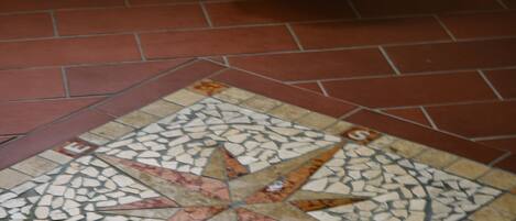 A tiled floor with a star pattern and a woven basket.