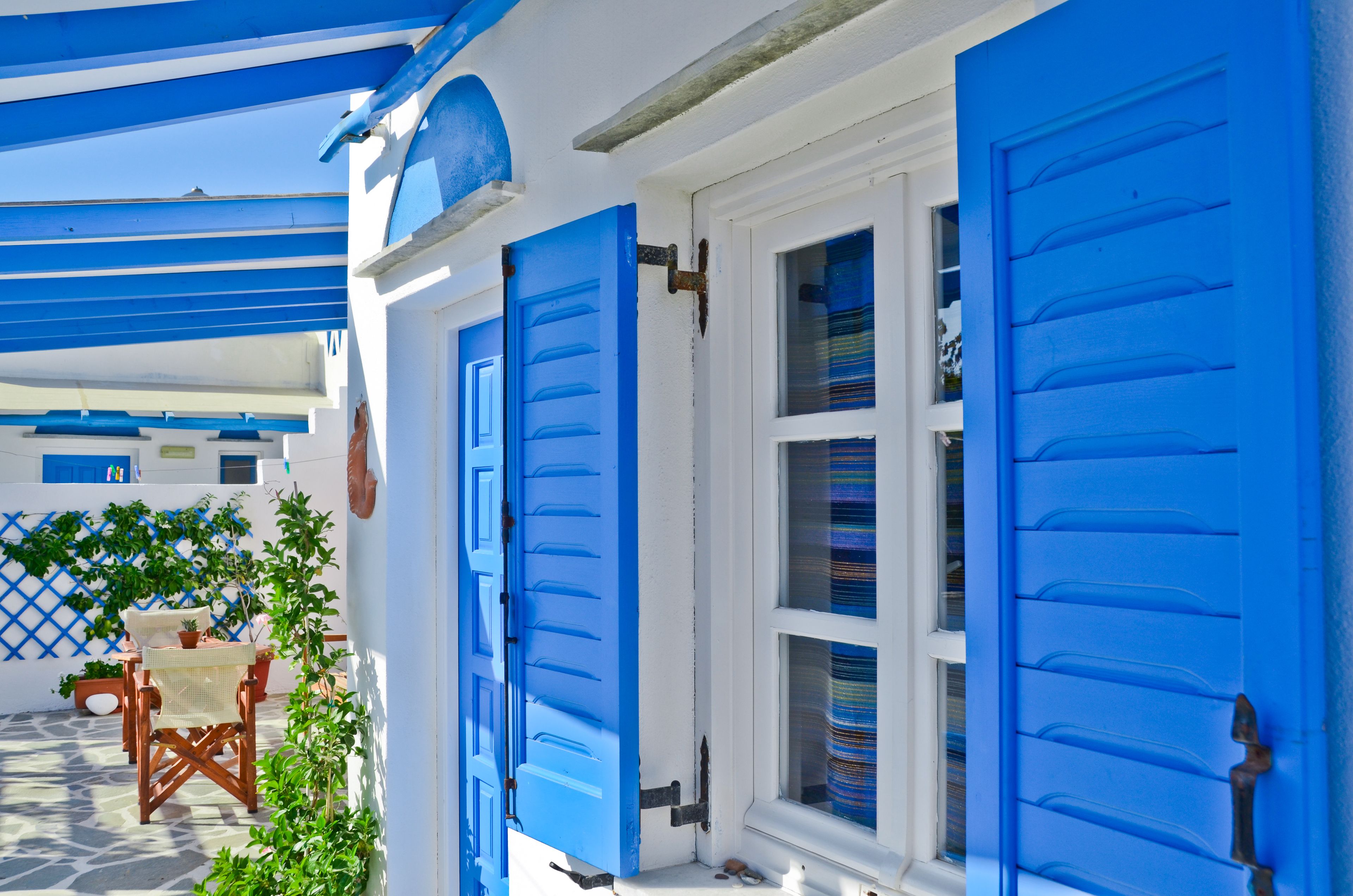 A building with blue shutters and a white exterior.