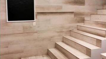 A staircase with wooden steps and a wall-mounted picture frame.