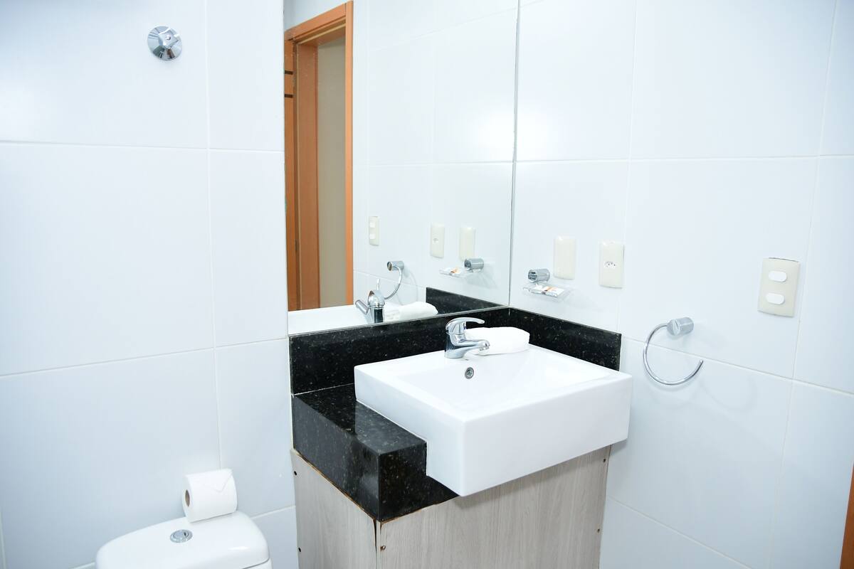 deluxe room | bathroom | shower, hair dryer, towels