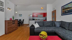 A modern apartment with a living room, dining area, and kitchen. - Villa Makar with  infinity heated pool,gym,grill, 3 bedrooms,3 bathrooms (Dalmatia)