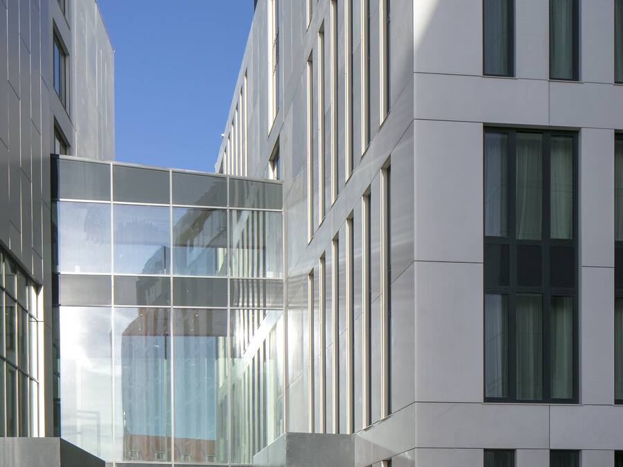 A modern building with a glass facade, large windows, and a clean, geometric design.