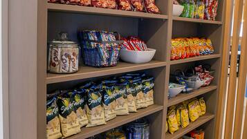 A pantry with various food items and containers.