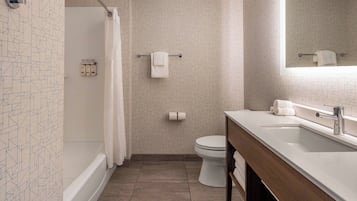 A modern bathroom with a bathtub, toilet, and sink.