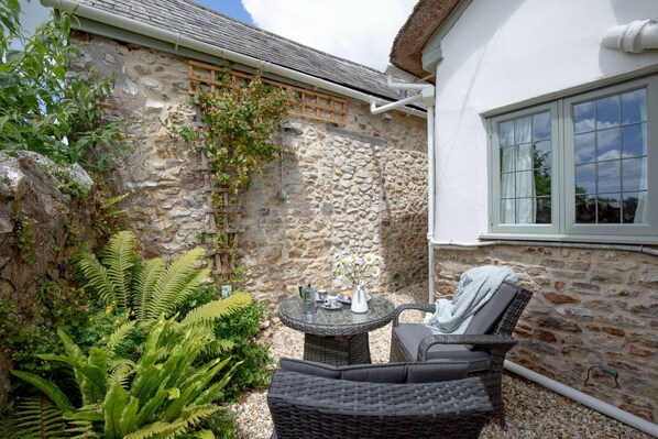 A stone building with a window and a wicker chair outside. - Kite's Holt, Stockland, Honiton , Devon (Stockland, Honiton)