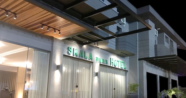 The exterior of the Skala Park Hotel with a modern design, featuring a prominent sign and a covered entrance.