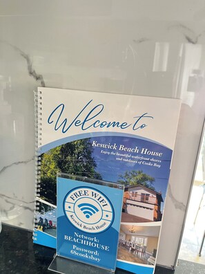 A welcome brochure for Keswick Beach House, highlighting free WiFi, a beach view, and a beachfront location.