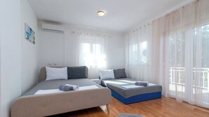 A modern bedroom with two beds, a wooden floor, and large windows with sheer curtains. - JOSIP 1, 3 bedroom apartment, 230m from beach  (Okrug Gornji)